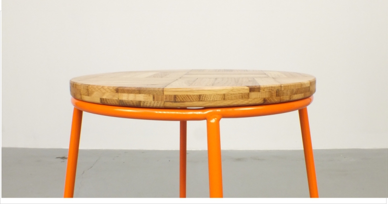 a close up of the reclaimed oak-parquet seat of the hand crafted high stool